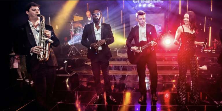 Premium live entertainment experience with musicians performing on stage in a vibrant, upscale event setting